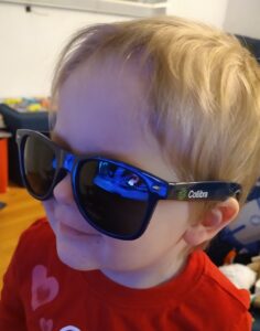 Small child wearing Collibra sunglasses